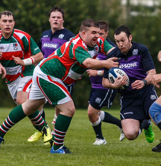 Mixed Ability Participants play rugby on a field