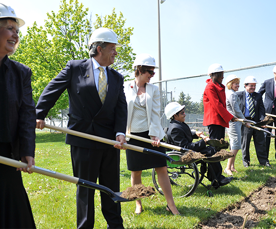 A group of founding community individuals holding shovels at Abilities Centre groundbreaking