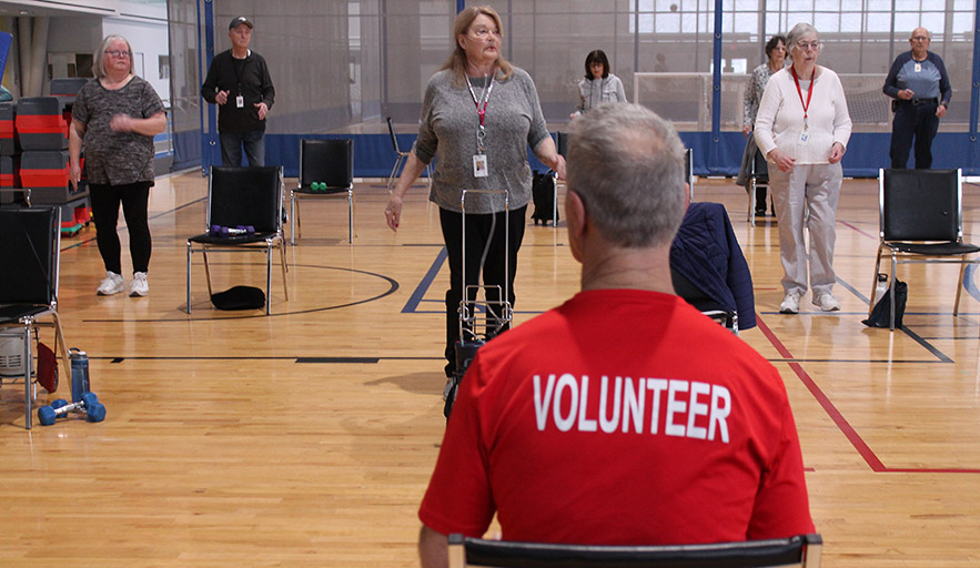 Volunteer actively supporting aerobic class instruction