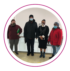 Leadership in Training participants stand together wearing masks on the Abilities Centre ramp