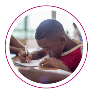 a child is sitting at a table working on homework